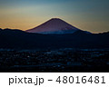 箱根の峰々に沈む夕日に照らされる富士山 48016481