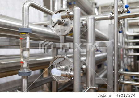 Steel pipelines and cables in factory interior as industrial zone background concept 48017574
