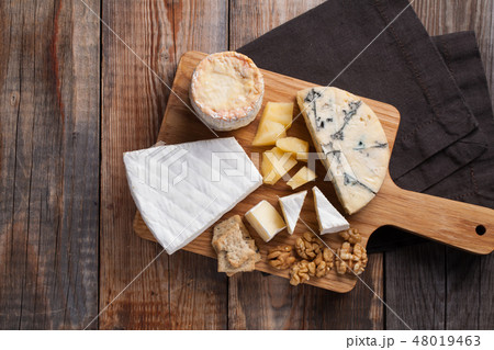 Tasting cheese dish on a wooden background. Tasting cheese dish on a wooden background. 48019463