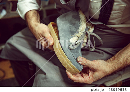 Enjoying process of creation custom made shoes. Workplace of shoe designer 48019658