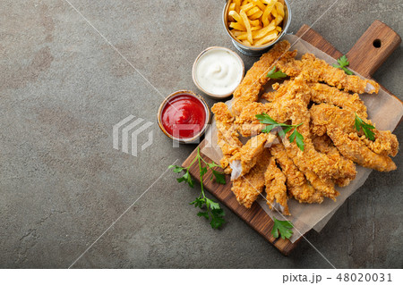 Breaded chicken strips with two kinds of sauces. Breaded chicken strips with two kinds of sauces. 48020031