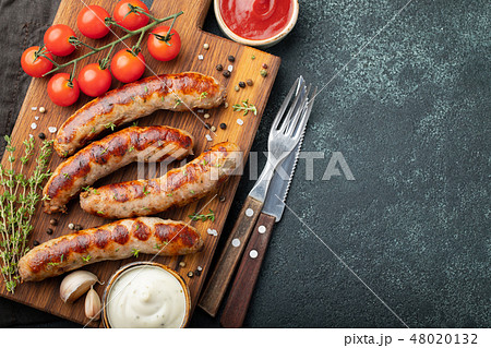 Fried sausages with sauces and herbs. Fried sausages with sauces and herbs. 48020132