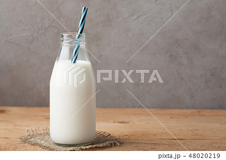 Bottle of milk on a wooden table. Bottle of milk on a wooden table. 48020219