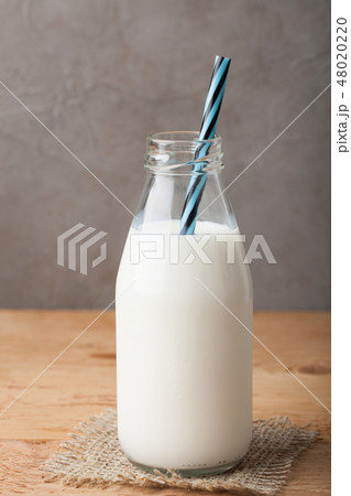 Bottle of milk on a wooden table. 48020220