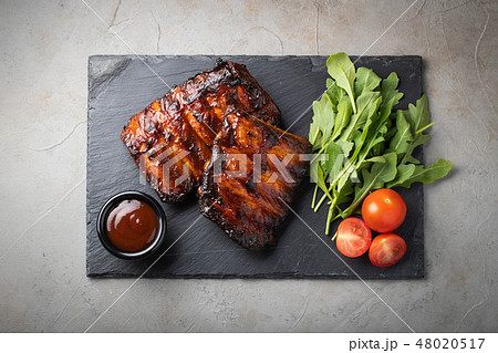 Closeup of pork ribs grilled with BBQ sauce. Closeup of pork ribs grilled with BBQ sauce. 48020517