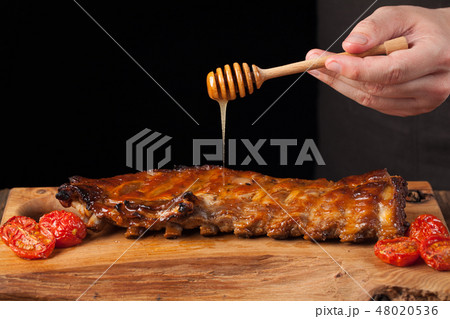 Cooking pork rib chops with honey sweet sauce. 48020536