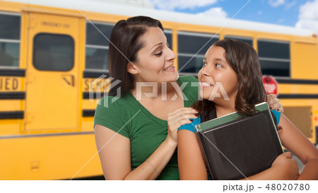Hispanic Mother and Daughter Near School Bus. Hispanic Mother and Daughter Near School Bus. 48020780