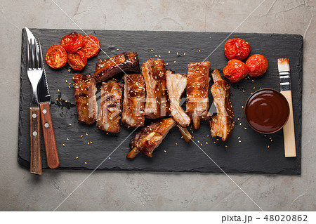 Grilled pork ribs in barbecue sauce. Grilled pork ribs in barbecue sauce. 48020862