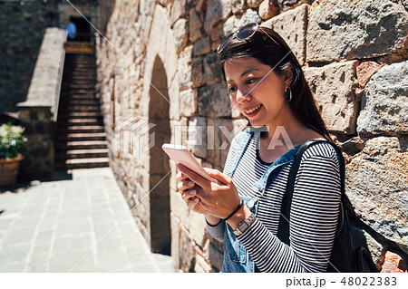 woman using cellphone checking the information woman using cellphone checking the information 48022383