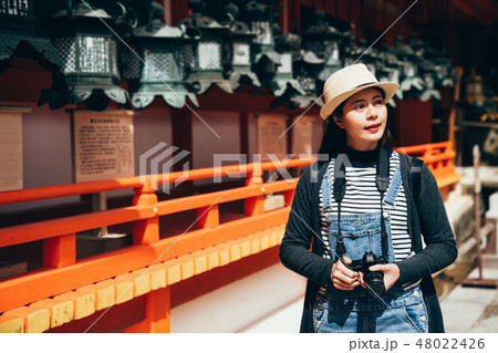 tourist holding camera cheerful visit 48022426