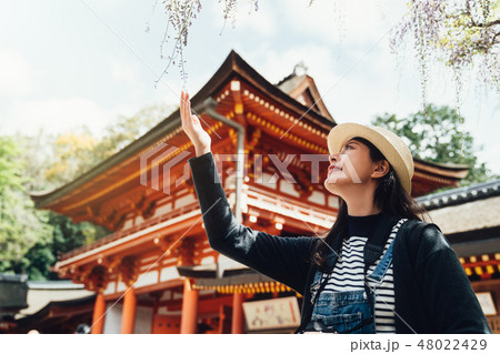 elegant woman touching blooming flower in spring elegant woman touching blooming flower in spring 48022429