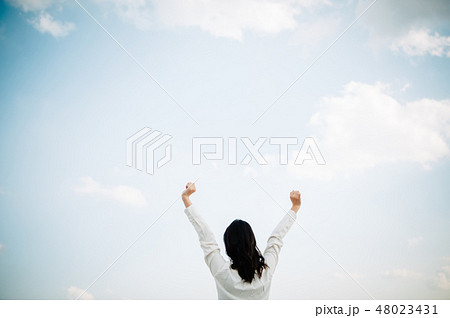 屋上に立つ白いシャツを着た女性 48023431