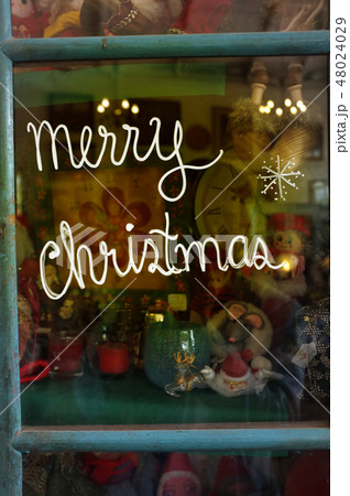 Merry Christmas text written on the glass 48024029