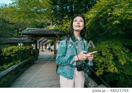 tourist reading guide book visit ujigami jinja 48025704