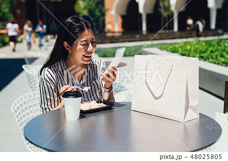 girl having lunch with coffee center mall. 48025805