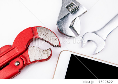 Plumbing key with a smartphone on a white background 48028221