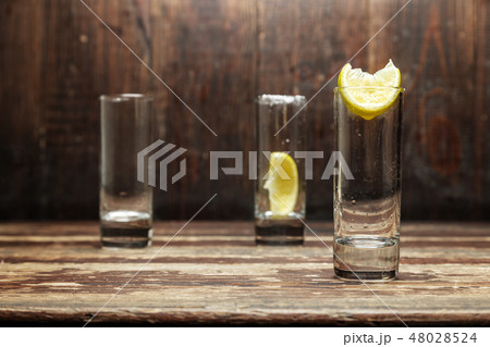 glasses with lemon glasses with lemon 48028524