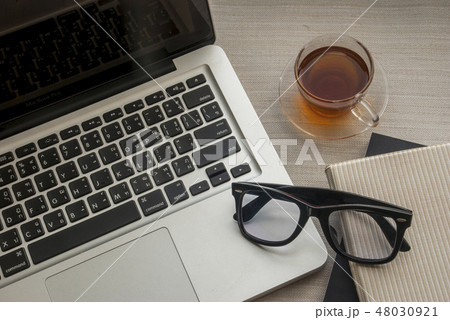 Laptop and one glass of work area 48030921