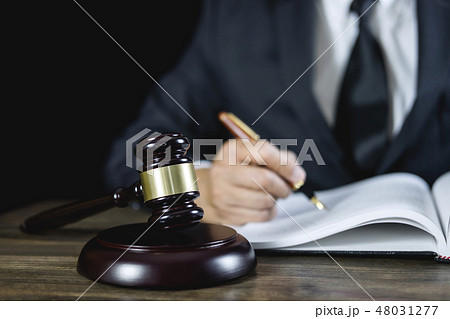 Counselor or Male lawyer working on courtroom sitting at the tab Counselor or Male lawyer working on courtroom sitting at the tab 48031277
