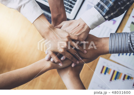 Business team shaking hands of unity after a meeting to sign agr 48031600