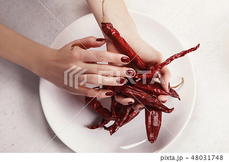 Beautiful female hand with red manicure Beautiful female hand with red manicure 48031748