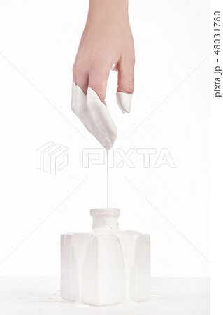 Beautiful woman hand with her white paint dripping 48031780