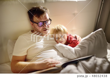 Father reading bedtime stories to child.  48032438