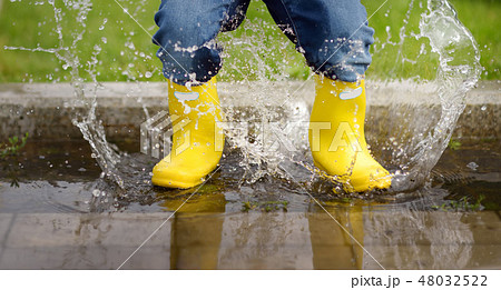 Toddler jumping in pool of water  48032522