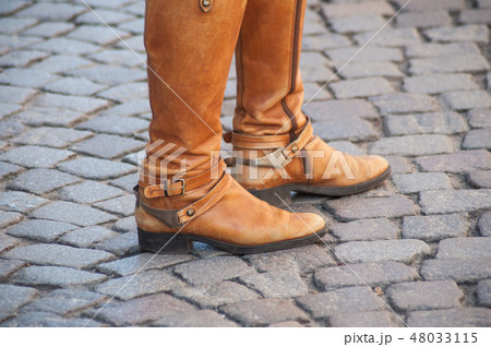 feet of woman with brown classic boots  48033115