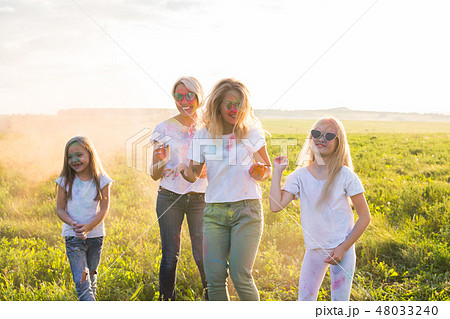 Friendship, Indian holidays and people concept - young women and children dancing on the summer 48033240