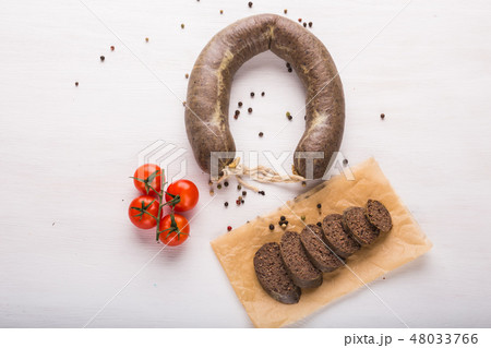Food, horse meat and delicious concept - top view of sliced sausage with tomato and pepper 48033766