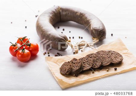 Food, meat and delicious concept - sausages made with horse meat with tomatoes on table Food, meat and delicious concept - sausages made with horse meat with tomatoes on table 48033768