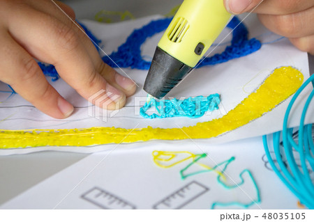 A persone drawing 3d pen that hardens in the air close-up. 48035105