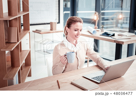 Blond-haired young journalist having coffee break Blond-haired young journalist having coffee break 48036477