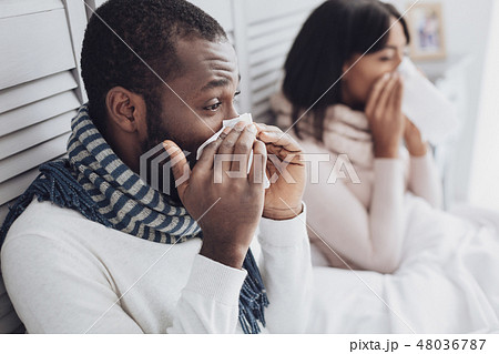 Young ill people blowing their noses 48036787