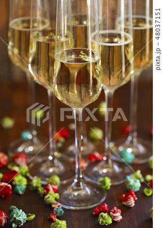 Champagne with pop corn on wooden background Champagne with pop corn on wooden background 48037151