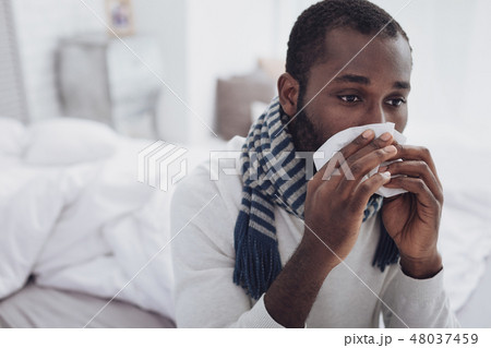 Upset male person being deep in thoughts 48037459