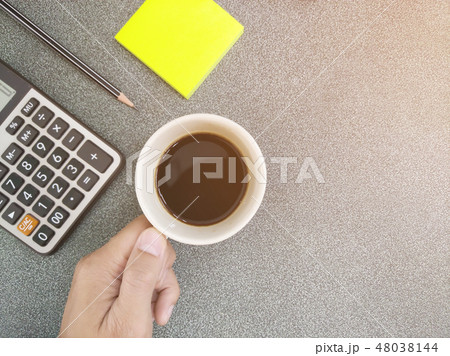 Coffee cup holders are on the desk. 48038144
