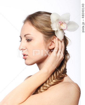 Portrait of the young blond girl with orchid 48040140