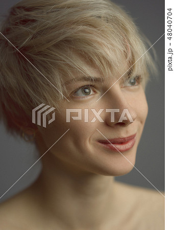 Modest woman smiling and looking up Modest woman smiling and looking up 48040704