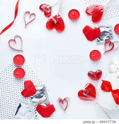 white background with red hearts, condoms, sweet 48047736