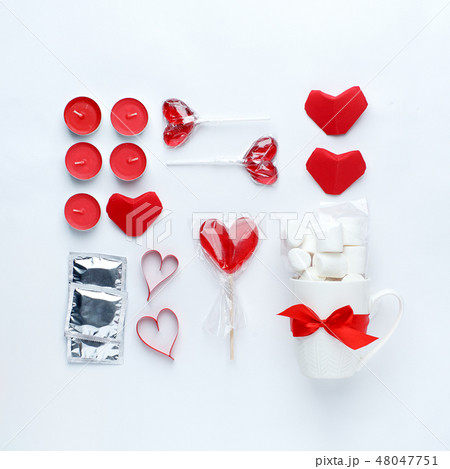 red decor, sweetness, red heart, condoms on white 48047751