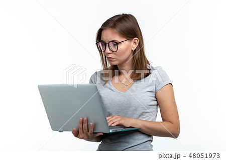 Study, education, people concept - young smart woman in glasses texting something on laptop Study, education, people concept - young smart woman in glasses texting something on laptop 48051973