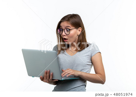 People and education concept - Surprised student woman holding a laptop over white background 48051974