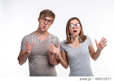 People and education concept - Two young funny student with thoughtful faces over white background People and education concept - Two young funny student with thoughtful faces over white background 48051977