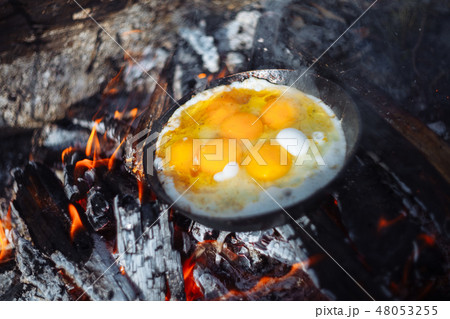 Fried eggs on the pan on the fire in winter 48053255