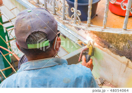 elderly welder works steel welding repair on roof elderly welder works steel welding repair on roof 48054064