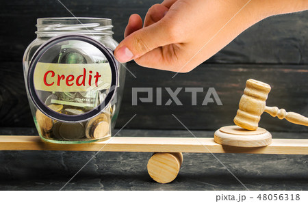 A glass jar with coins and the inscription Credit A glass jar with coins and the inscription Credit 48056318