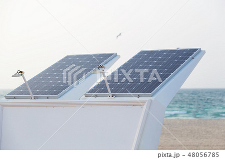 Photovoltaic panel on top of shower standing on the beach 48056785