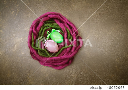 Wooden nest with Easter eggs on dark background 48062063